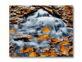 Art print with an image of a stream with wide green water flowing between two rocks.