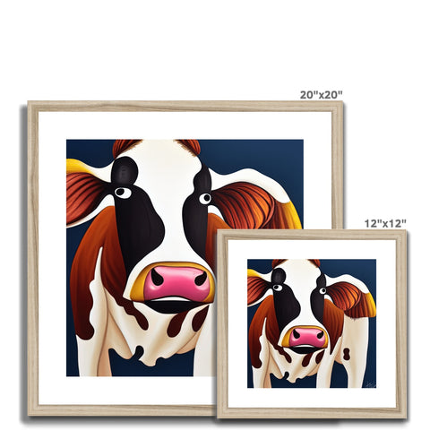a holstein cow staring at a photo frame of two cows on it's side at