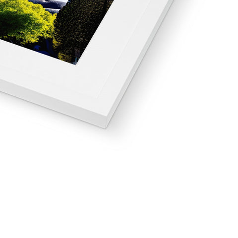 A softcover book in a white frame holding a white picture on a white background.