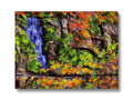A colorful picture of a waterfall with a wall hanging.