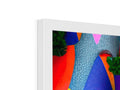 A colorful art print on an apple computer screen is placed on a table.