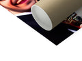 A close up of a toilet paper dispenser with a large roll of toilet paper.