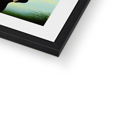 An image of a photo of a picture frame with framed print on it in black and