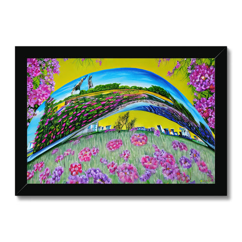 An image of a colorful flower field on a picture frame with a blue sky.