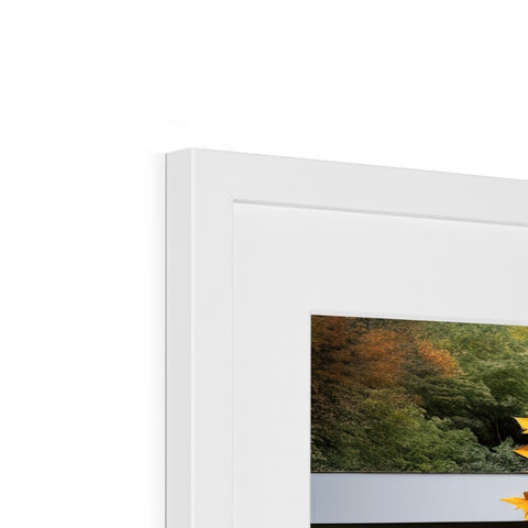 A picture frame with a yellow photo hanging onto a wall.