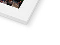 The image of a white picture frame on top of a frame is holding four photographs.