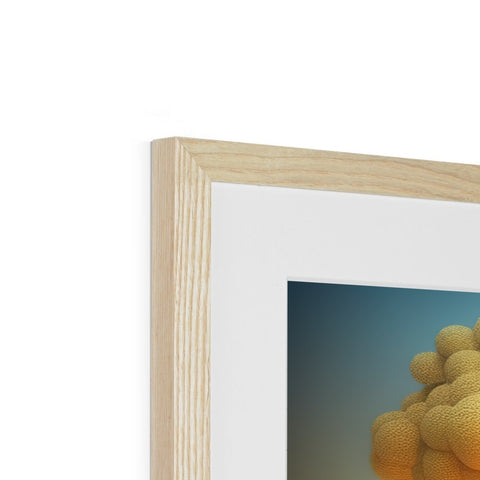 A photo of a gold flower photo framed in a wooden frame with glass.