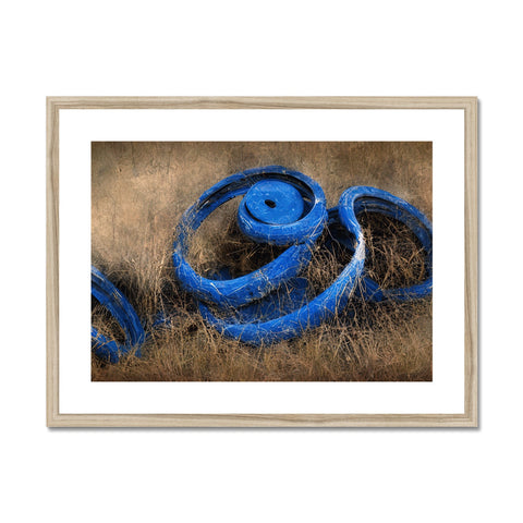 A blue ribbon framed print printed on a blue framed wooden object on a rug.