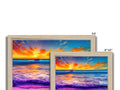 A picture frame with a black background, two photographs and a watercolor of a sunset