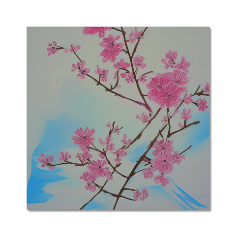 An art print of a pink blossom tree sitting on a table.