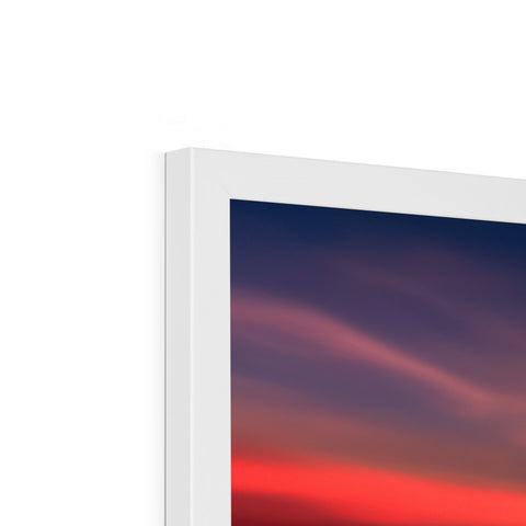 An imac monitor sitting on top of a white screen on a white couch.