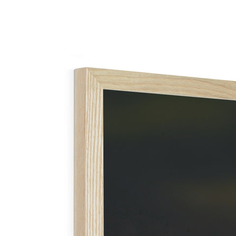A picture frame is in one of two frames holding a wooden frame.