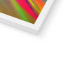 A white picture frame with a red background and green border next to an abstract painting on