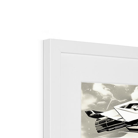 A miniature airplane is sitting on a white background on a picture frame.