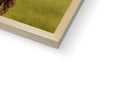 A close up of a picture with wood frame holding a book on top of it.