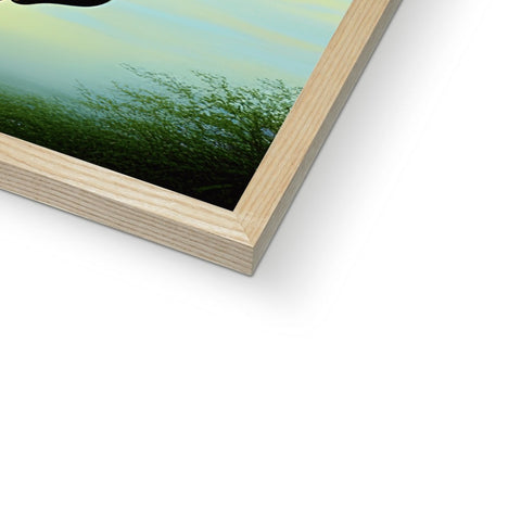 A book cover in a dark wooden photo frame over a green wall.