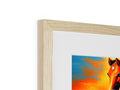 A wooden picture frame that has a closeup of a horse in grass.