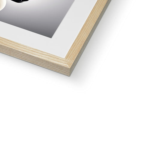 a picture frame containing a black picture on a white piece of wood