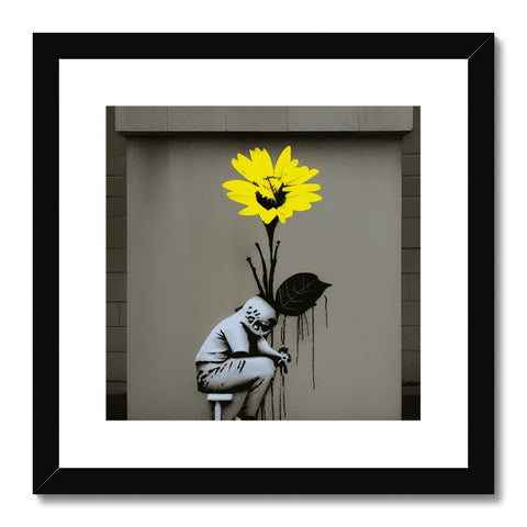 An art print on a wall standing next to a large yellow flower.