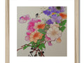 A beautiful floral art print on a piece of wood hanging on a wooden frame next to