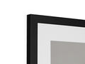 A white picture frame on the side of a wall that is framed with three different colors