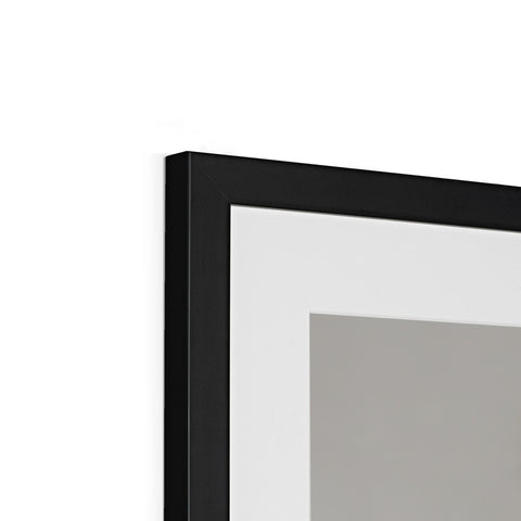 A white picture frame on the side of a wall that is framed with three different colors