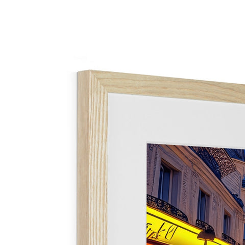 a white picture frame with a picture on top of a wooden background being framed in wood