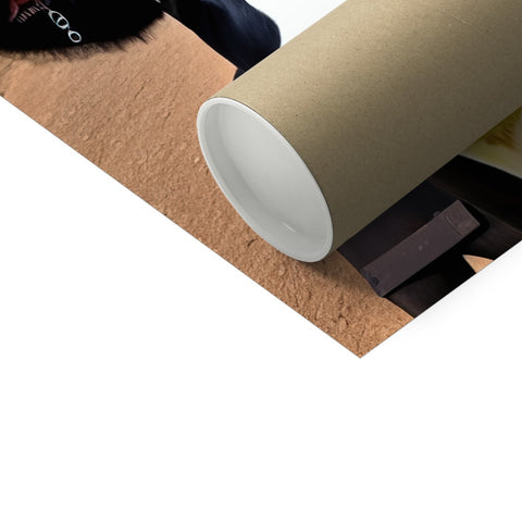 A paper roll with a photo of a toilet behind it.