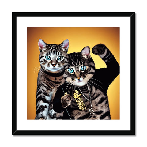 Two cats sitting on a wall under an art print.