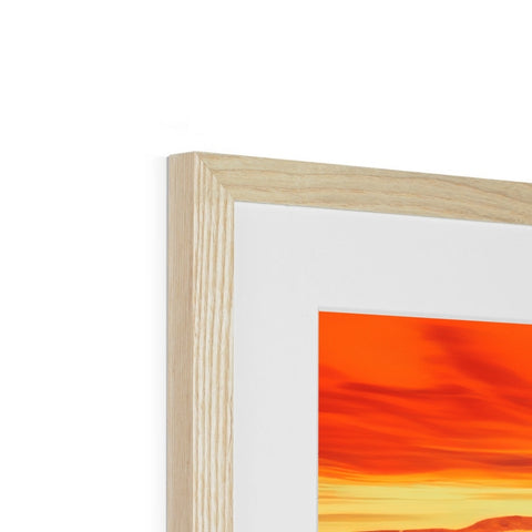 A wooden picture frame with a picture of the sun on a white backdrop standing next to