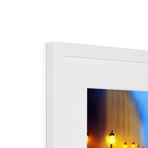 A lighted picture frame sitting on top of a fireplace fireplace mantel with candles.