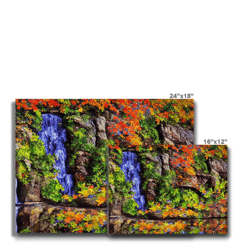 A waterfall in the background of a picture of rocks off a paved area.