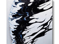 A black and white painting on ceramic tile sits in front of waves.