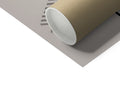 A paper roll on top of a toilet table is held by a roll of paper.