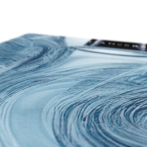 A blue cloth with water prints covered on it in bed.
