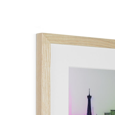 A photograph is put together in a wooden frame on top of some pieces of furniture.