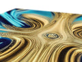 a colorful piece of marble covered in gold foil floating in the water
