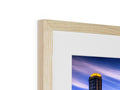 A framed photo in wood is sitting on top of a white background.