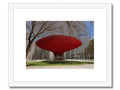 A piece of art on a picture of a building with a red hat on top of