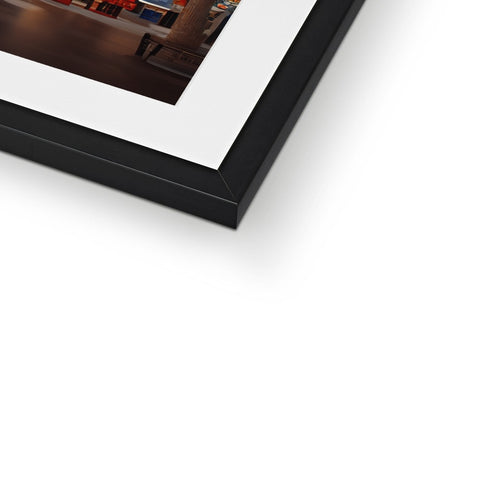 A framed photo of a single photograph on a table next to a frame.