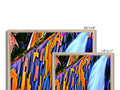A large display of computer monitors with two pictures overlapped near each other.