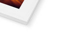 A picture frame with a white and black photo is holding an imac.