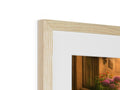 A white picture frame framed in wood with a mirror on top of it