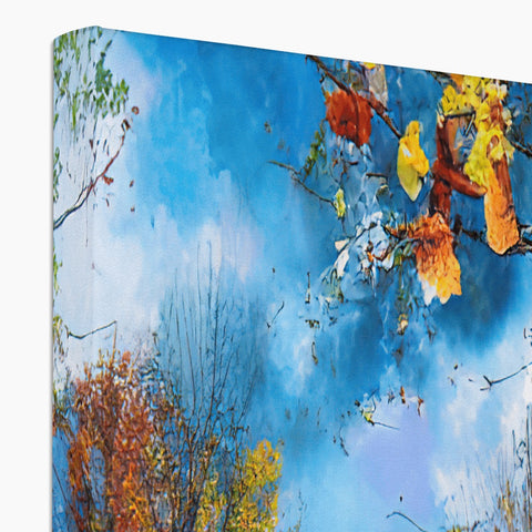 A decorated box with an art print of trees and an autumn tree on a table.