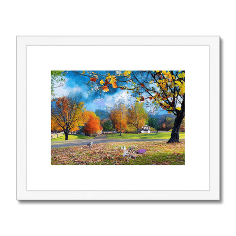 Several pictures of fall foliage and a man sitting under a tree with a dog in the