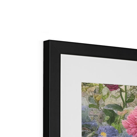 A large picture in a picture frame with two small framed flowers sitting on top of it