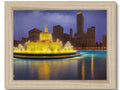 A framed picture of the city skyline of Chicago on blue and gold colored wood wood.