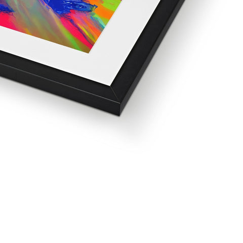 An abstract art print hanging on wooden frames next to a picture in a white frame.