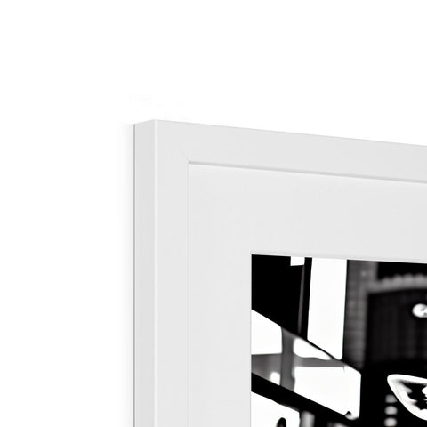 A black and white photo frame hanging on a wall next to a banner.