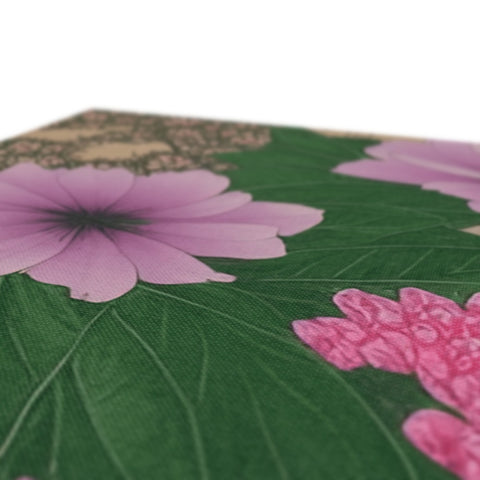 A pillow with purple petals and flowers on the side of it.